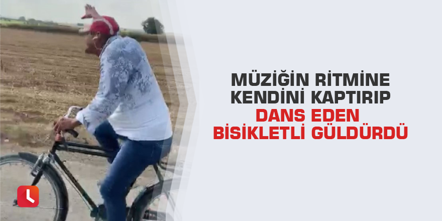 Müziğin ritmine kendini kaptırıp dans eden bisikletli güldürdü
