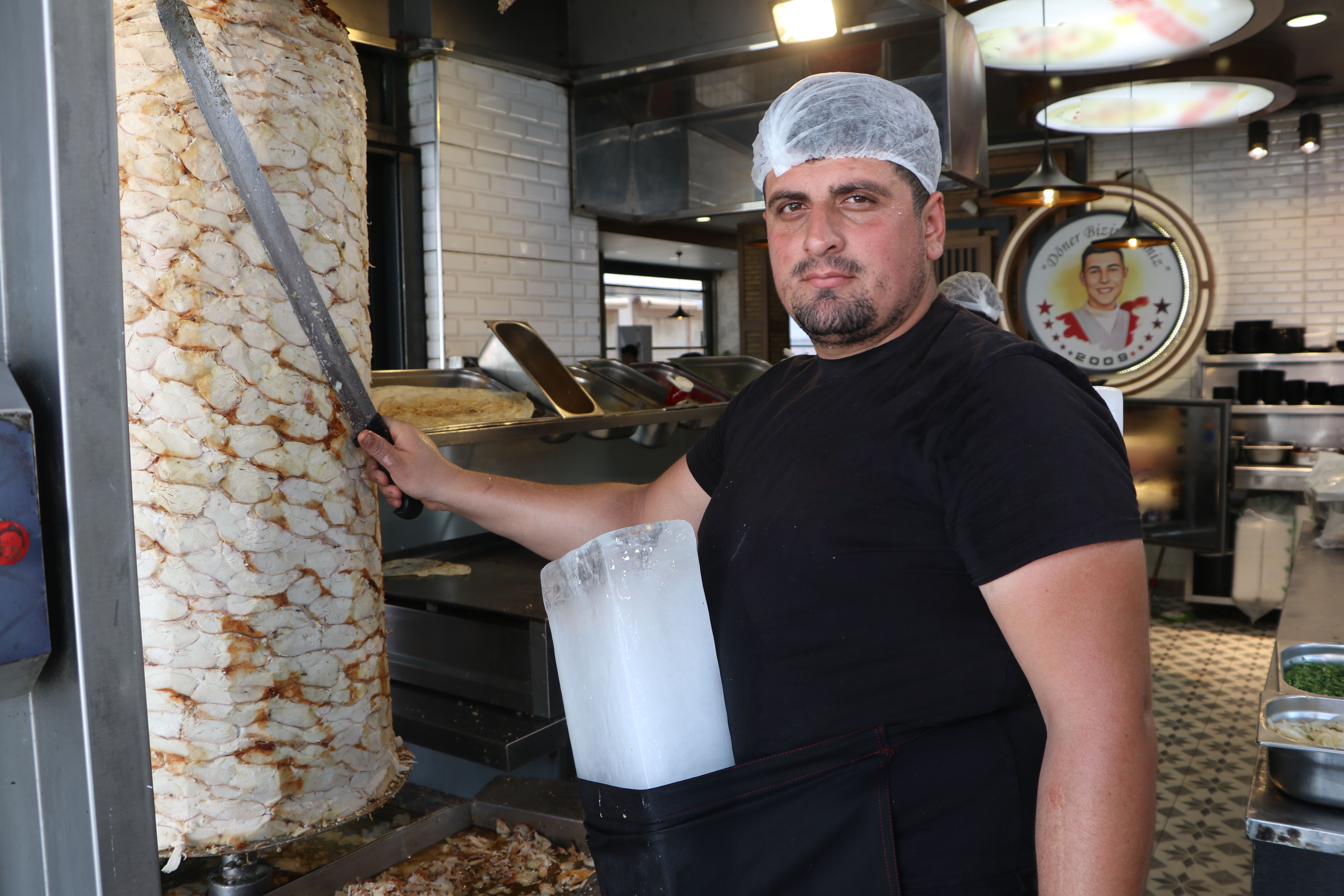 Adana sıcağına buzlu çözüm: Döner ustası kalıp buzla çalışıyor