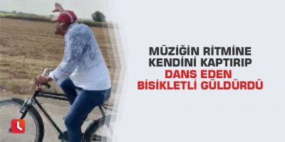 Müziğin ritmine kendini kaptırıp dans eden bisikletli güldürdü