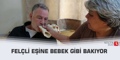 Felçli eşine bebek gibi bakıyor