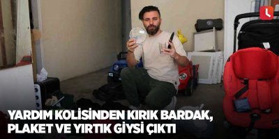 Yardım kolisinden kırık bardak, plaket ve yırtık giysi çıktı