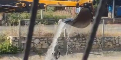 Sıcaktan bunalan vatandaşın imdadına kepçe operatörü yetişti